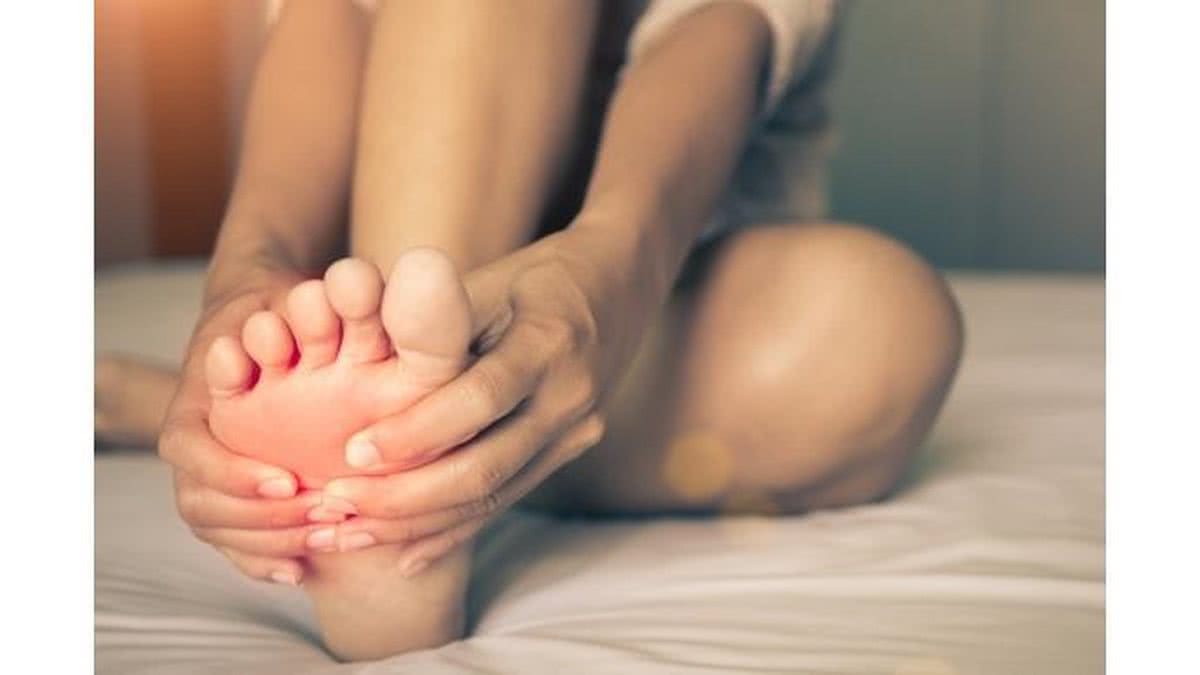 health-care-concept-woman-massaging-her-painful-foot-red-hilighted-on-picture-id835071070