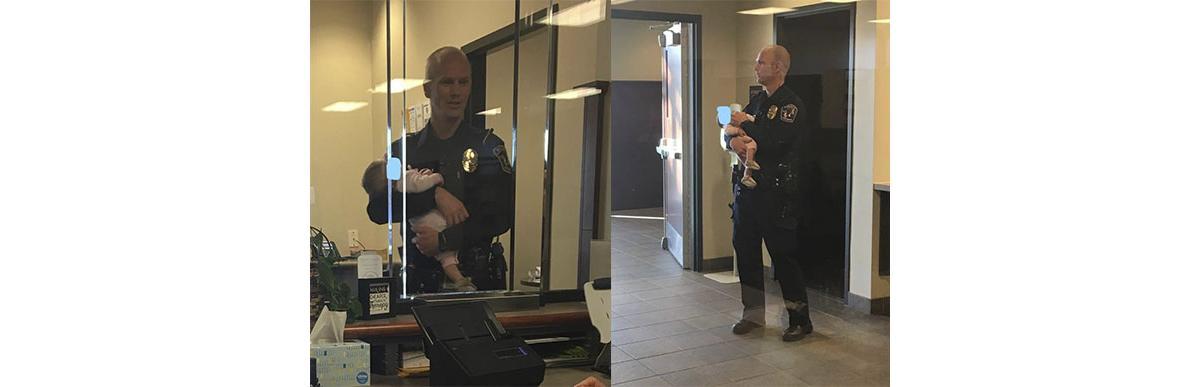 O policial ficou horas com o bebê no colo (Foto: Reprodução/ Facebook)
