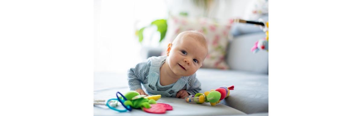 cute-baby-boy-playing-with-toys-in-a-sunny-living-room-picture-id871598028